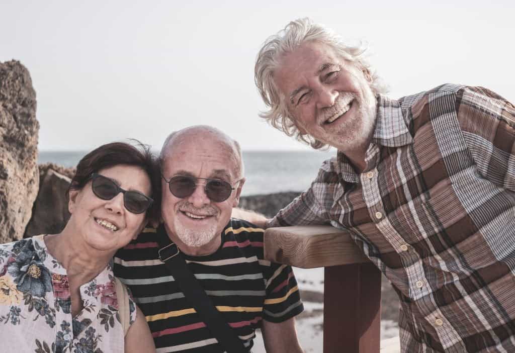 Smiling group of senior people enjoying sea excursion. Active lifestyle for three retired people